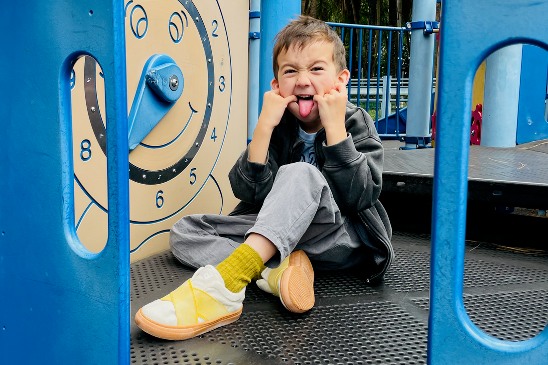 Preschool child wearing sustainable kids sneakers walking in the city. second-hand kids shoes guide